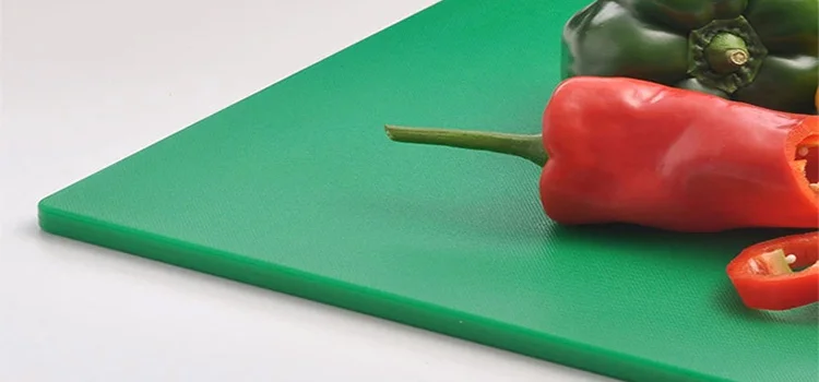 Red and Green bell pepper on green shopping board