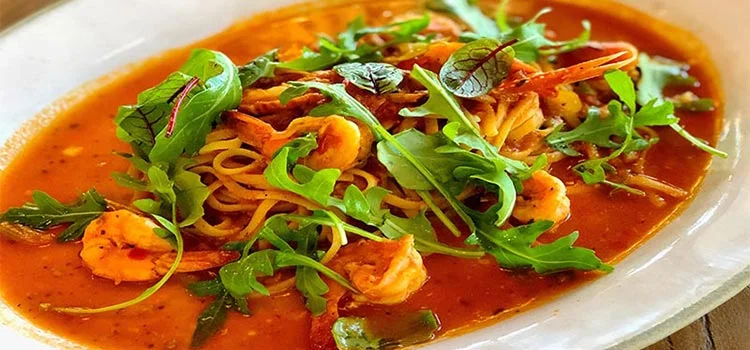 Famous Italian dish Prawn Linguine served with herbs in a white dish
