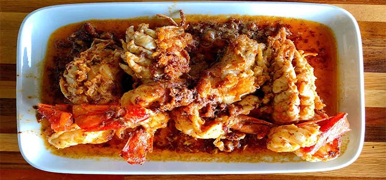 Mouthwatering garlic prawns served in a white dish