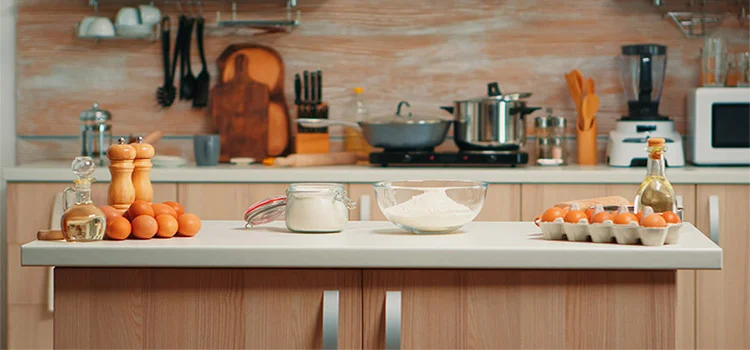 A clean kitchen table with foods and various ingredient 