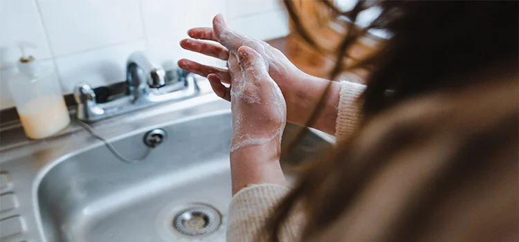 Woman washing her hands with soap