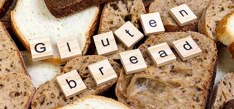 Close-up of Gluten bread text on sliced bread on the top of table