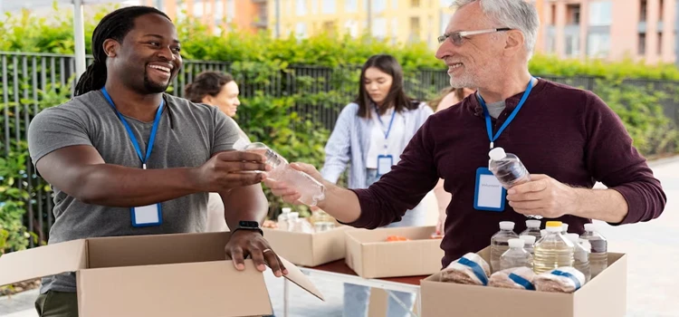 Group of people happily volunteering at a food bank 