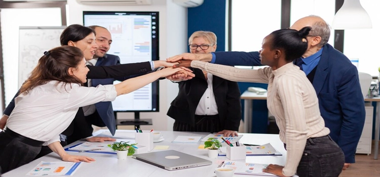 Close-up of cheerful, overjoyed business people in conference room celebrating success